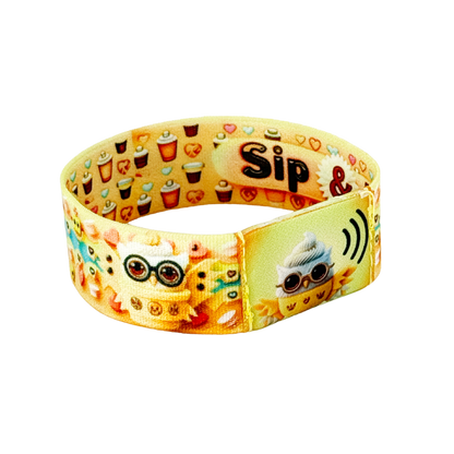 Lay the band flat on a neutral background and frame a close-up of the front patch, making sure “Drop & Sip” text and the cup-owl graphic are sharply in focus.