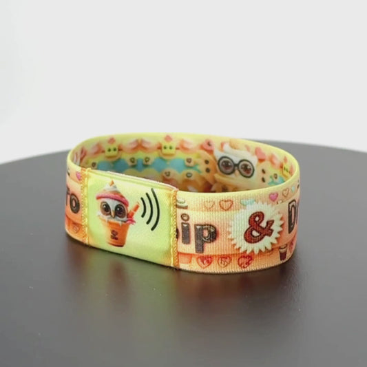 Continue the spin to reveal the reverse side—show the dense pattern of colorful cups and hearts—all the way around the wrist.